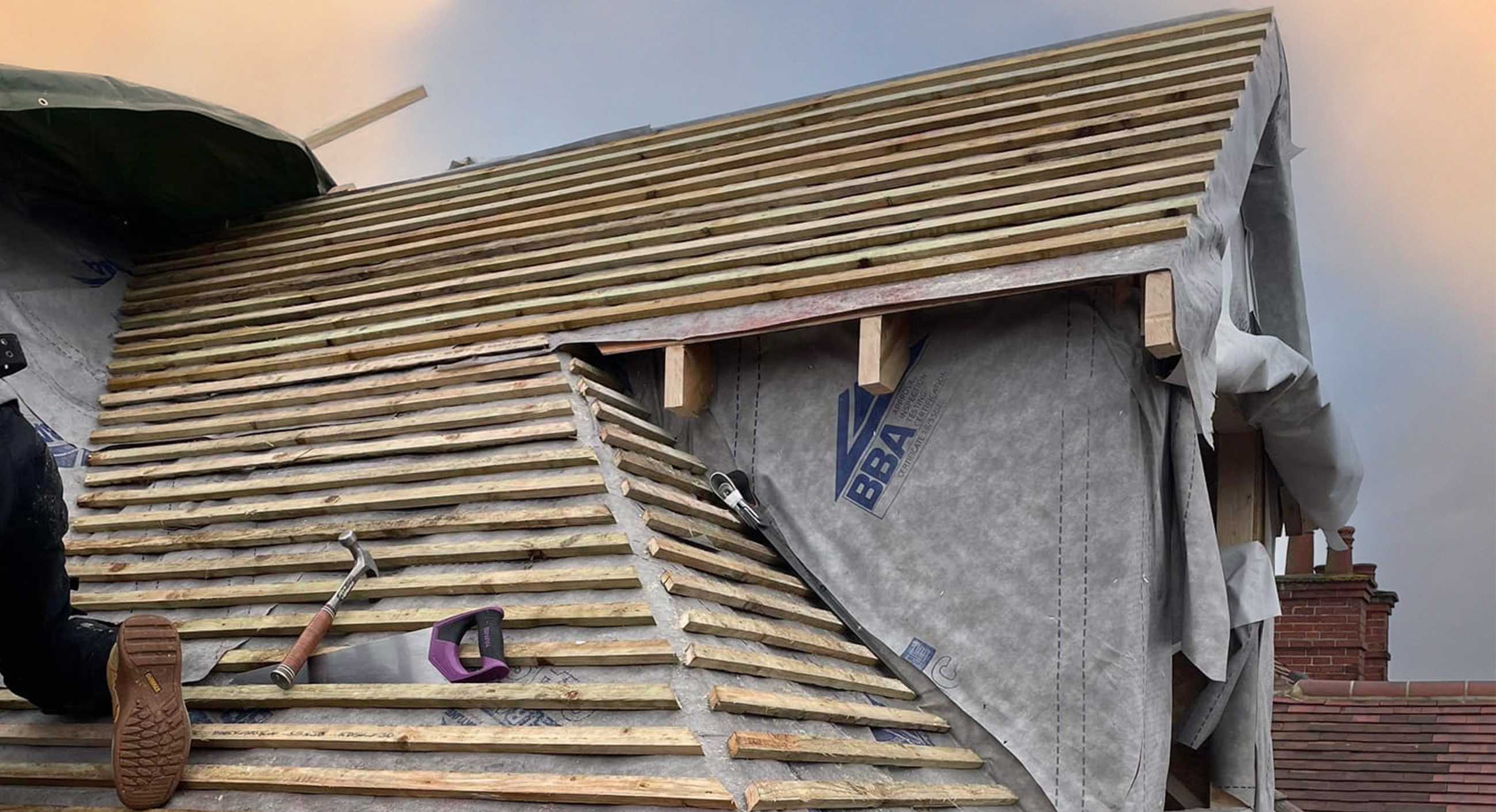 Loft converison with bare brick wall and Velux window