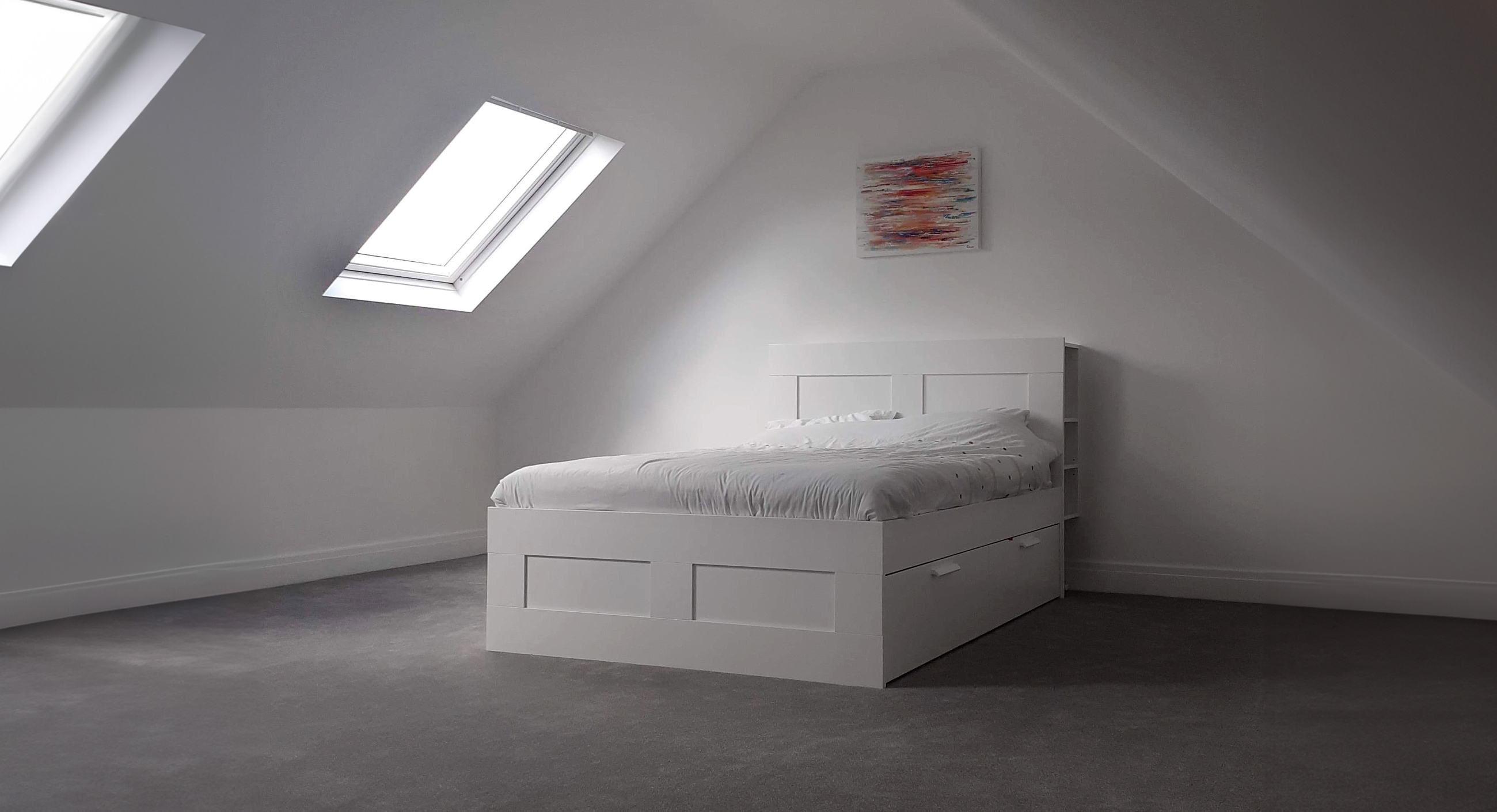 Loft converison with bare brick wall and Velux window