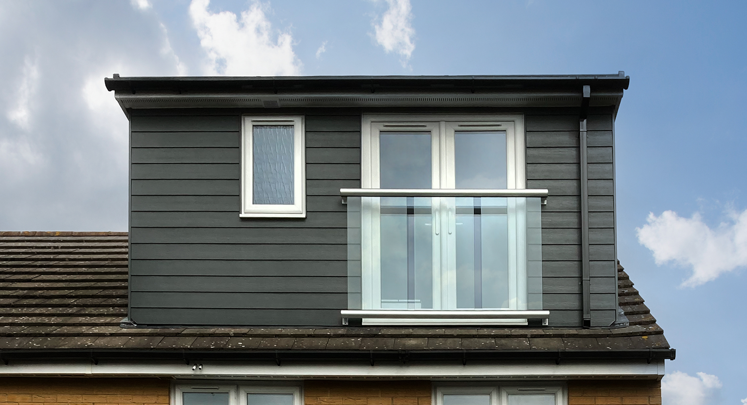 Loft converison with bare brick wall and Velux window